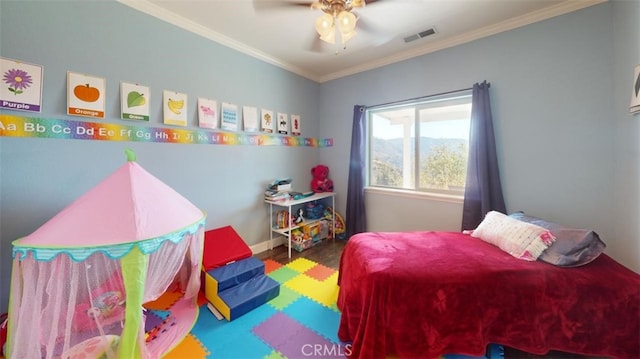 bedroom featuring ornamental molding, wood-type flooring, and ceiling fan