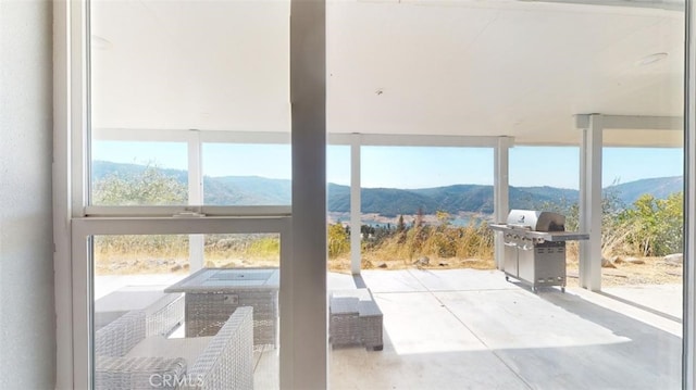 doorway with a mountain view and concrete flooring