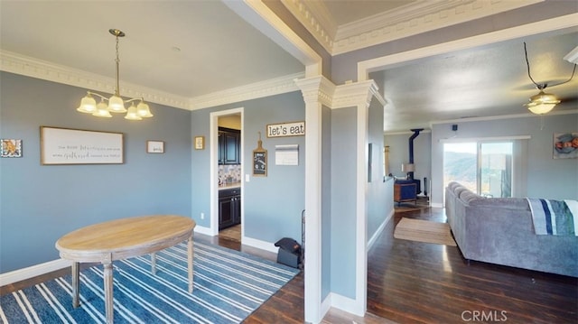 dining space with crown molding, dark wood-type flooring, and decorative columns