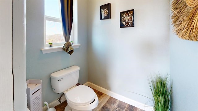 bathroom with hardwood / wood-style floors and toilet