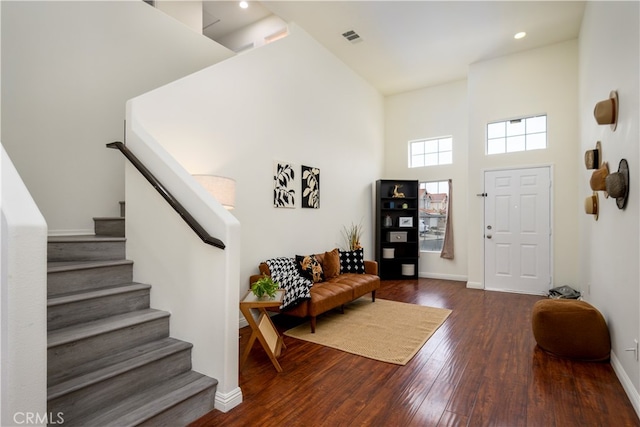 entrance foyer with dark hardwood / wood-style flooring and a high ceiling