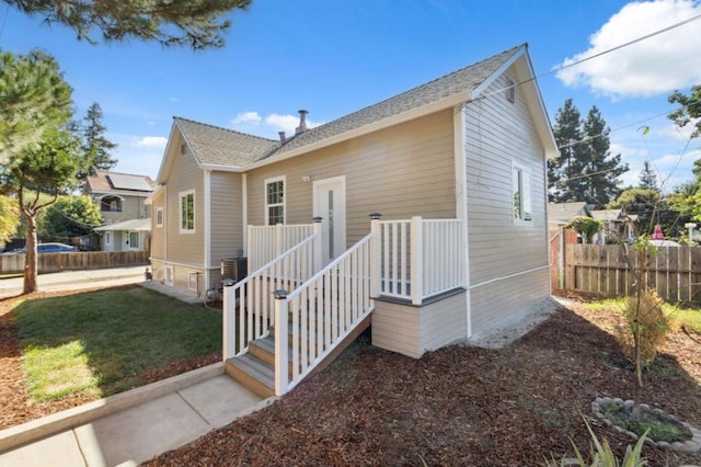 view of side of property with a lawn