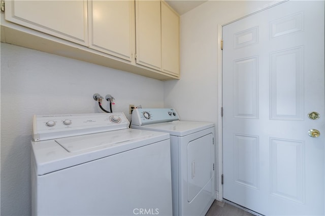 laundry room with cabinets and separate washer and dryer