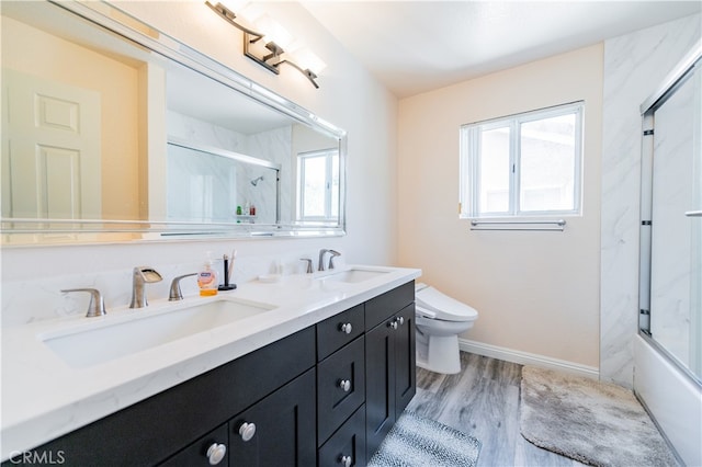 full bathroom featuring vanity, hardwood / wood-style floors, toilet, and enclosed tub / shower combo