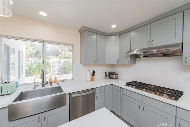 kitchen with stainless steel appliances, sink, and gray cabinetry