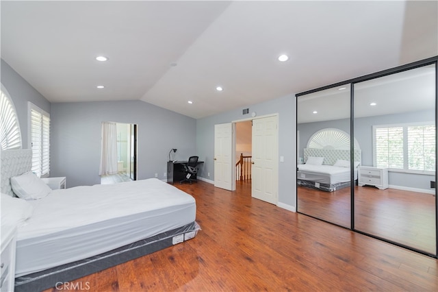 bedroom with hardwood / wood-style floors and vaulted ceiling