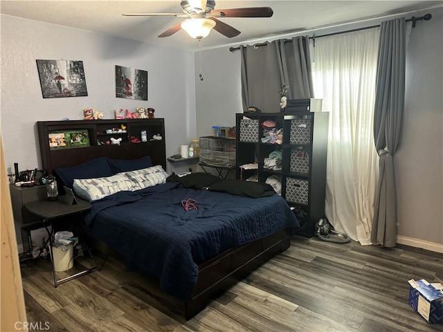 bedroom with hardwood / wood-style floors and ceiling fan