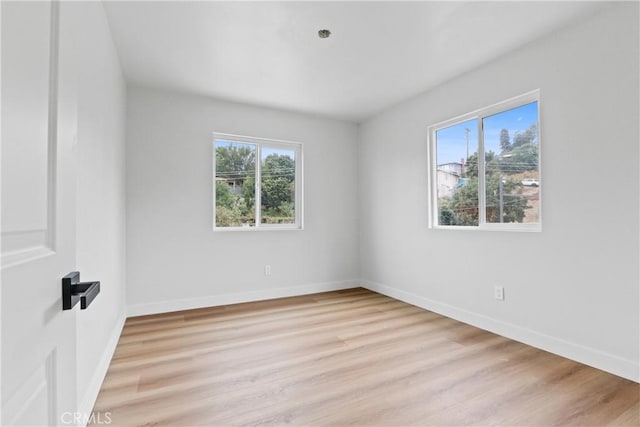 unfurnished room with light wood-type flooring