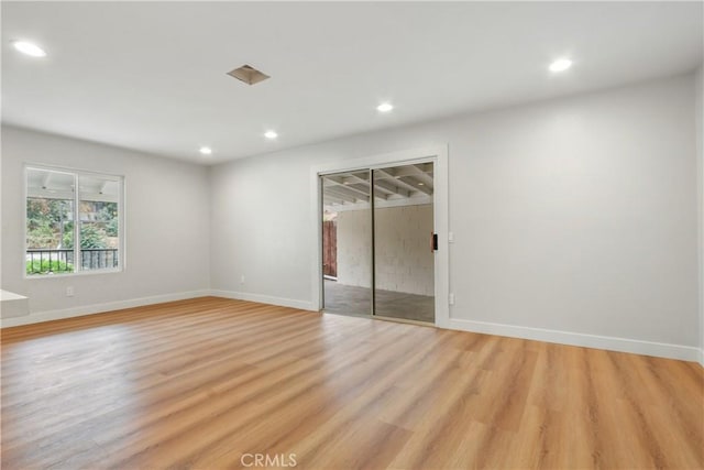 spare room featuring light hardwood / wood-style floors