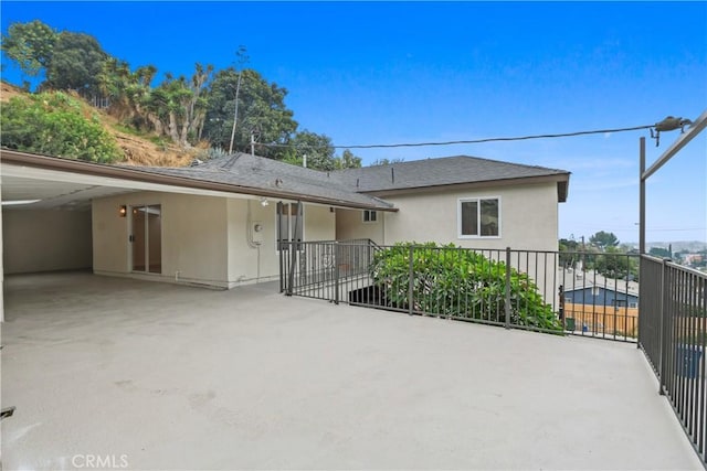 rear view of property with a carport