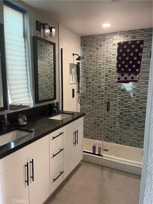 bathroom featuring tile patterned floors, vanity, and walk in shower