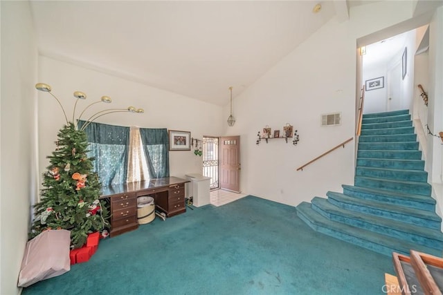 interior space featuring light colored carpet and high vaulted ceiling