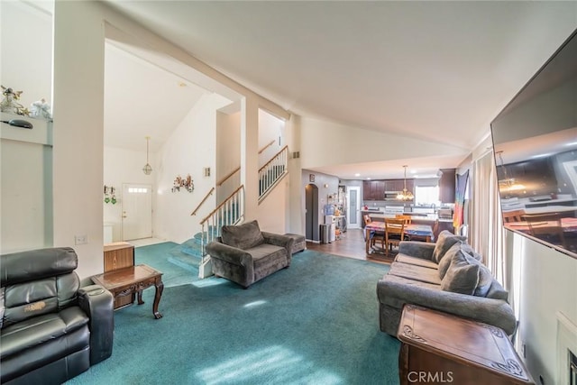 living room featuring wood-type flooring and high vaulted ceiling