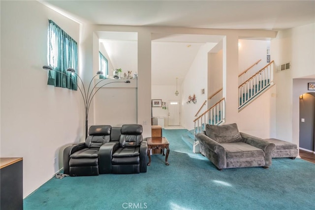 carpeted living room featuring vaulted ceiling