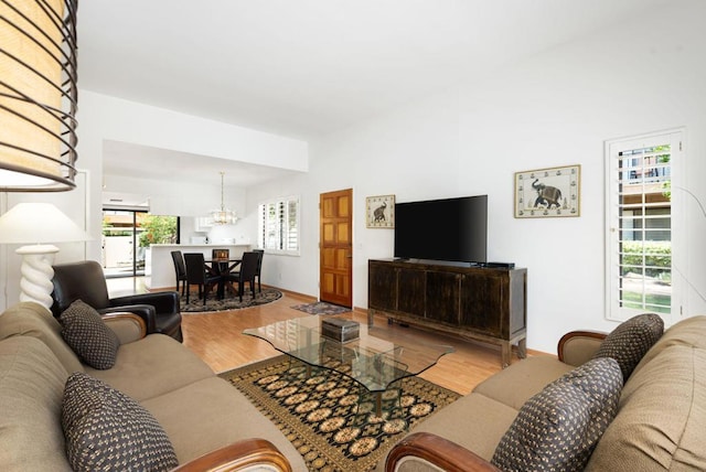 living room featuring wood-type flooring and a chandelier