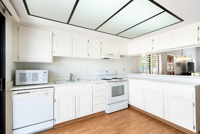 kitchen with white cabinetry, sink, and white appliances