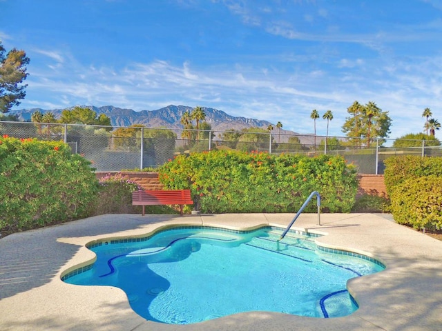 view of pool featuring a mountain view and a patio area