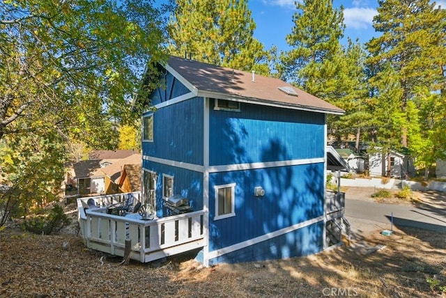 view of side of property featuring a deck