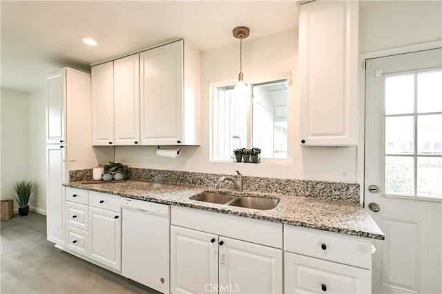 kitchen with dishwasher, white cabinets, decorative light fixtures, and sink