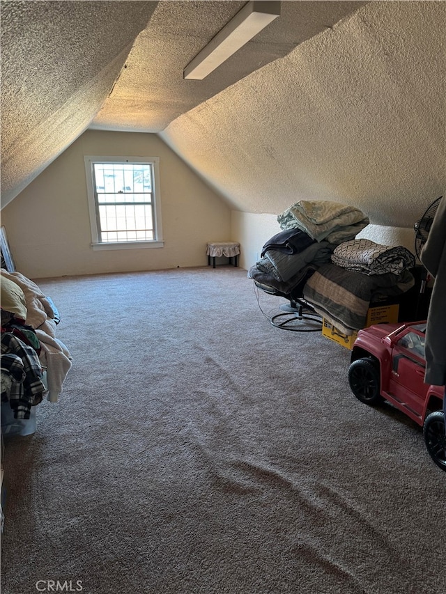 bonus room with lofted ceiling, a textured ceiling, and carpet flooring