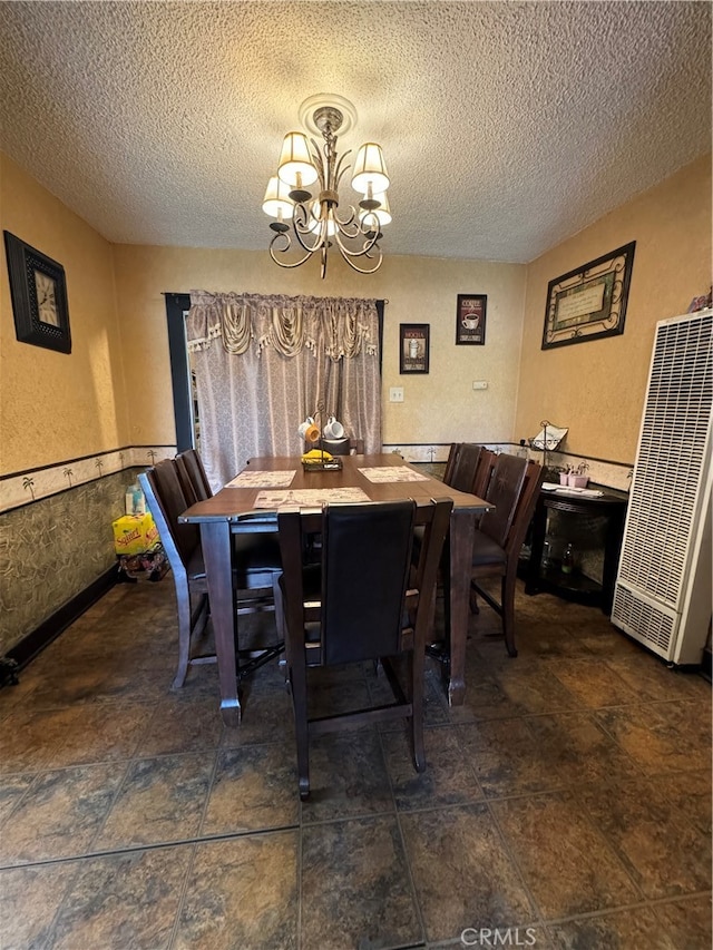 dining space with a chandelier and a textured ceiling