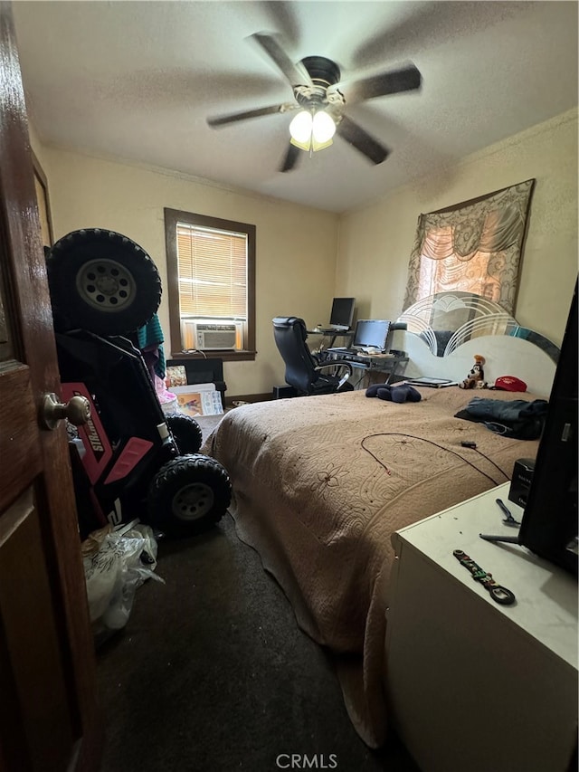 bedroom with a textured ceiling, carpet flooring, and ceiling fan