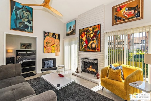 living room with plenty of natural light, ceiling fan, a fireplace, and vaulted ceiling