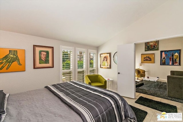 bedroom featuring light tile patterned floors and vaulted ceiling