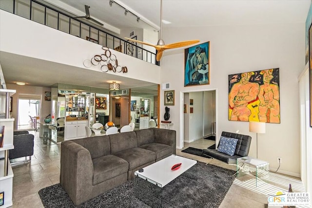 living room with rail lighting, high vaulted ceiling, and ceiling fan