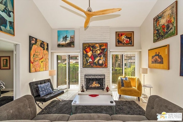 living room featuring a wealth of natural light, ceiling fan, and vaulted ceiling