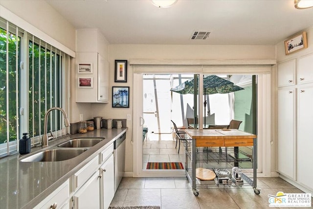 kitchen featuring a healthy amount of sunlight, white cabinetry, and sink