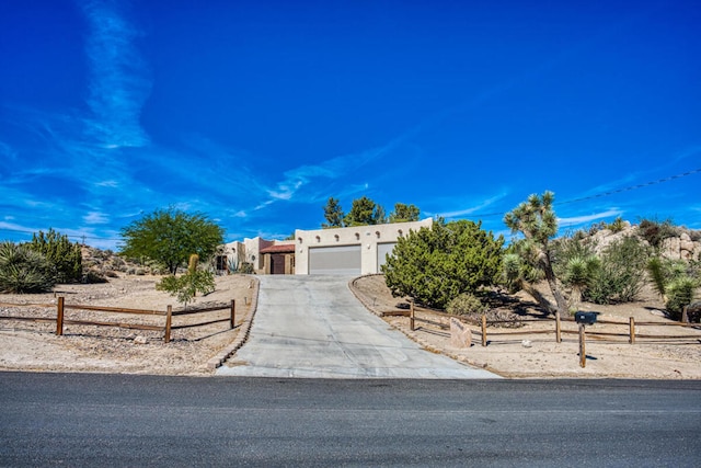 pueblo-style home with a garage