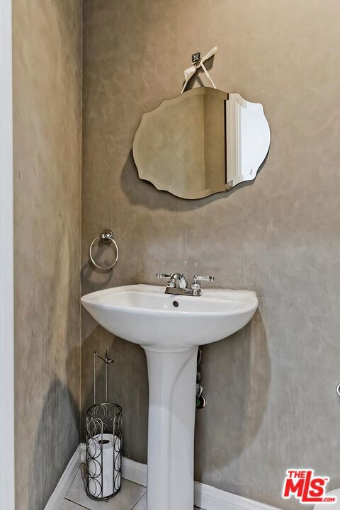 bathroom featuring sink and tile patterned flooring