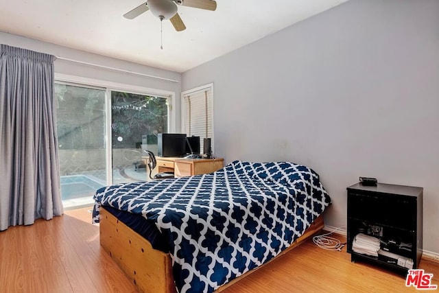 bedroom featuring access to exterior, wood-type flooring, and ceiling fan