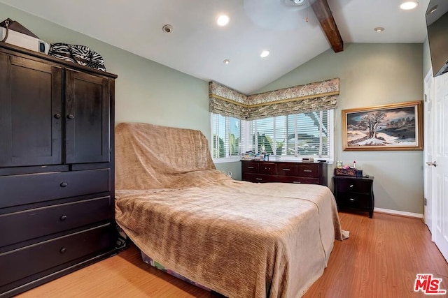 bedroom with light hardwood / wood-style floors, vaulted ceiling with beams, and ceiling fan