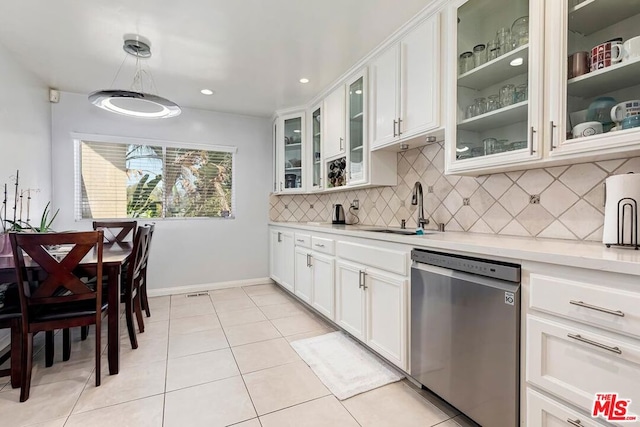 kitchen with dishwasher, sink, hanging light fixtures, white cabinetry, and light tile patterned floors