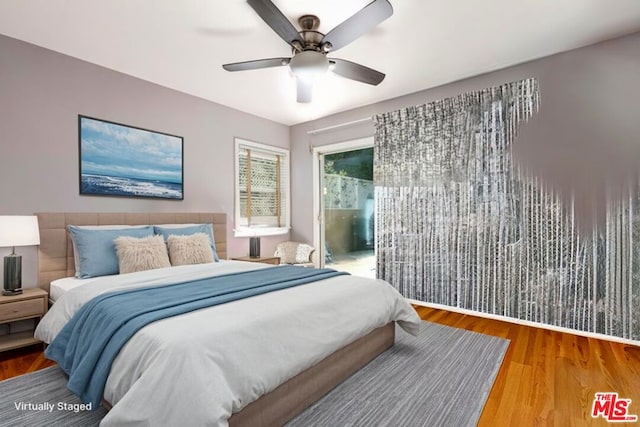 bedroom with wood-type flooring and ceiling fan