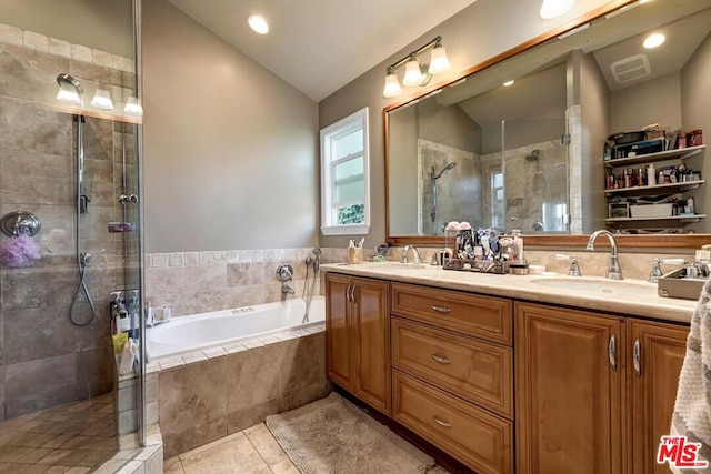 bathroom with vanity, lofted ceiling, independent shower and bath, and tile patterned floors