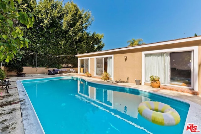 view of swimming pool with a patio