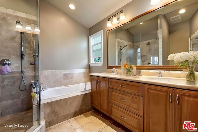 bathroom with vanity, lofted ceiling, independent shower and bath, and tile patterned floors