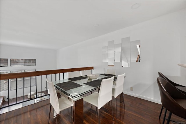 dining space with dark hardwood / wood-style floors