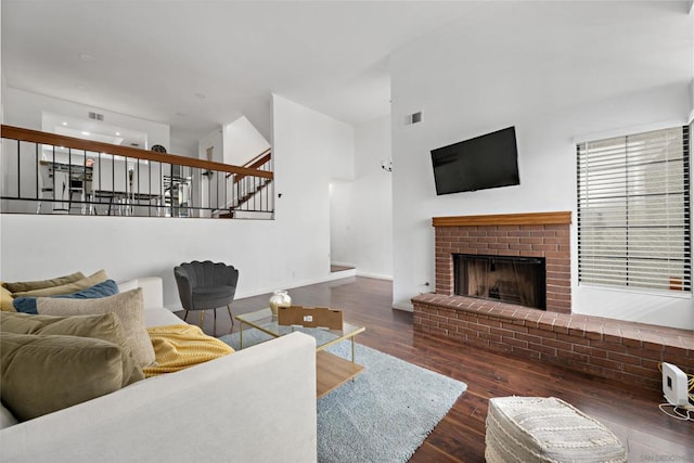 living room with a fireplace and dark hardwood / wood-style floors