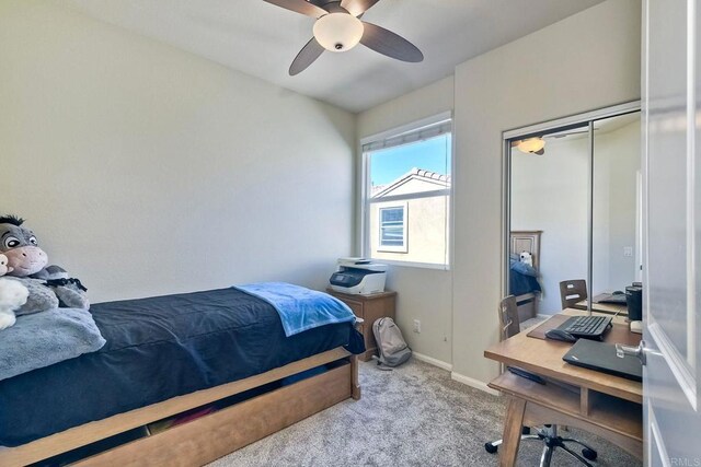 carpeted bedroom with a closet and ceiling fan