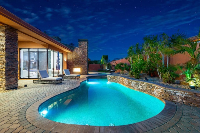 pool at night with a patio