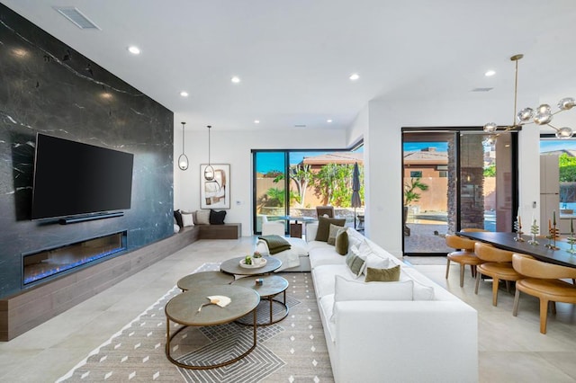 living room featuring an inviting chandelier and a fireplace