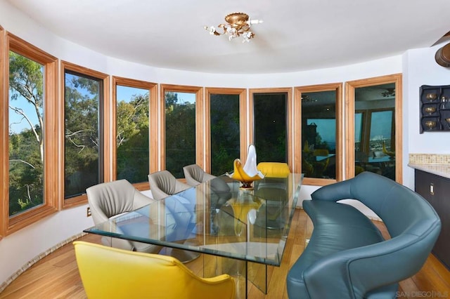 sunroom / solarium with a notable chandelier