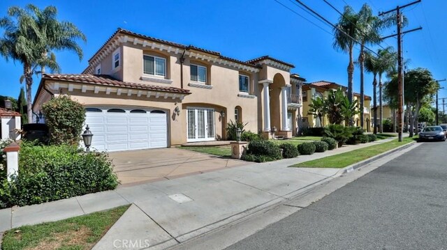 mediterranean / spanish-style house featuring a garage and french doors