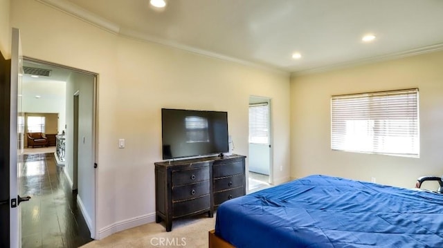 bedroom with light hardwood / wood-style flooring and ornamental molding