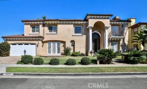 mediterranean / spanish-style home with a garage