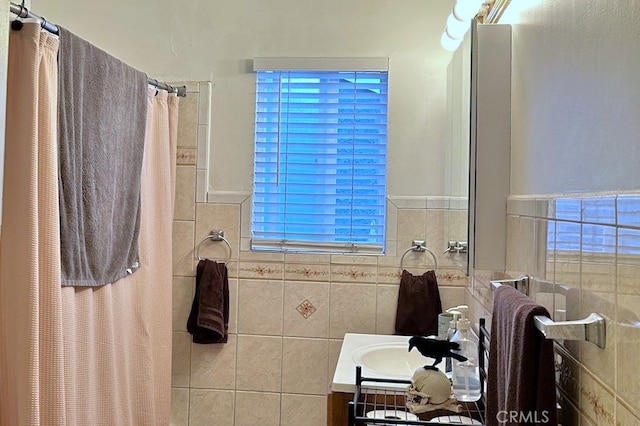 bathroom featuring vanity, tile walls, and walk in shower